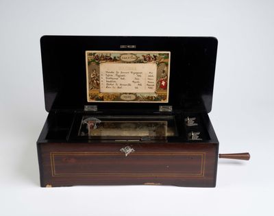 a small musical box with a note inside of it