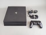 a video game console and a game controller on a table