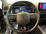 the interior of a car with a steering wheel and dashboard controls