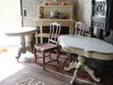 a table and chairs in a room with a rug on the floor
