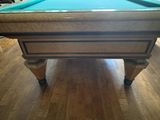 a pool table with a blue cloth on it