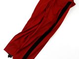 a close up of a red pants with black stripes on it