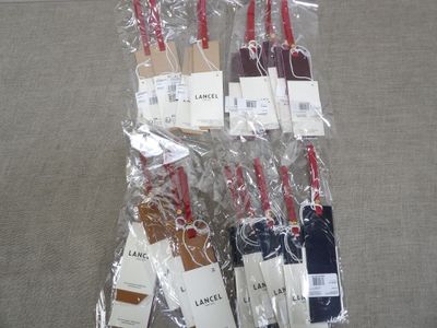 six bottles of wine wrapped in plastic bags on a couch