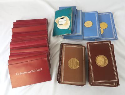several books are stacked on top of each other on a bed