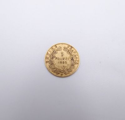 a gold coin on a white surface with a white background