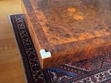 a coffee table that is sitting on a rug in a living room