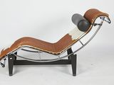 a brown and white chaise lounger with a black leather seat