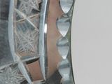 a mirror that has a design on the side of it