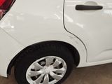 a white car with a black rim parked in a garage
