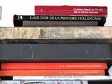 several books are stacked on top of each other on a table