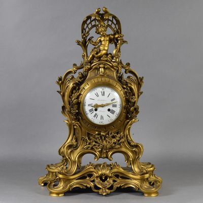 a gold clock that is sitting on a table