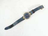 an image of a wrist watch with a blue dial on a white surface