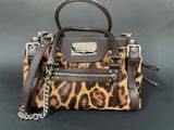 a brown and black purse with a leopard print pattern on it