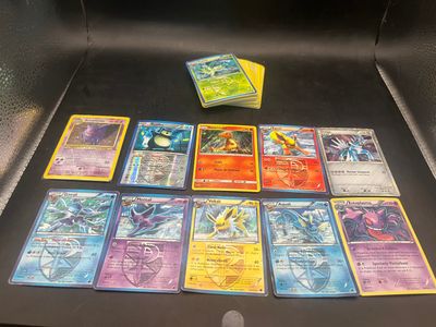 a lot of pokemon cards on the table