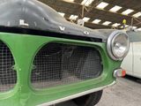 a close up of a green truck in a garage