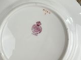 a white plate with a red design on it