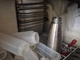 a drawer full of cups and other items in a kitchen