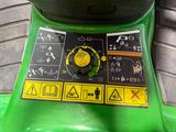 a close up of a green machine on the ground
