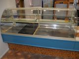 a blue counter with a glass display case in it