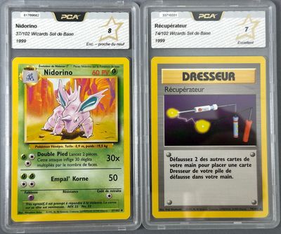 two pokemon cards with different designs on them on a table