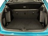 the back of a blue car with its trunk open showing the cargo area