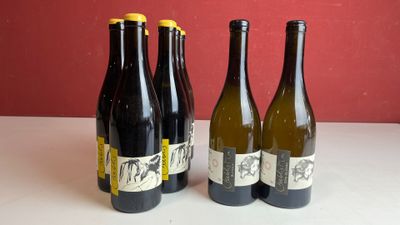 quatre bouteilles de vin sont alignées sur une table