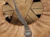 a brown leather helmet with a metal buckle on it