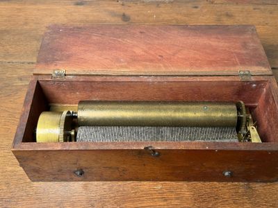 a wooden box that has a musical box inside of it