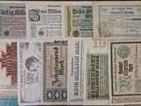 some old paper money sitting on top of a wooden table
