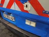 a close up of a blue and white van with a red and white stripe