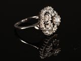 a close up of a diamond ring on a black surface