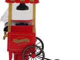 une machine à pop-corn rouge surmontée d'un auvent rouge