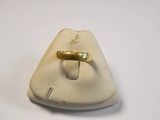 a gold ring sitting on top of a white plate