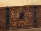 a wooden trunk with writing on it sitting on a table