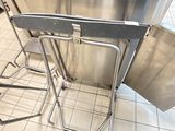 une table et des chaises en acier inoxydable dans une cuisine
