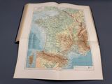 an open book with a map of france on top of it