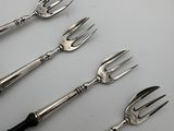a lot of forks that are sitting on a table