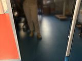 a man standing next to a door in a room
