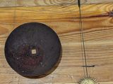 a wooden table with a metal object on top of it