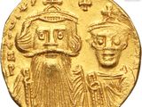 a gold coin with an image of a man and a woman on it