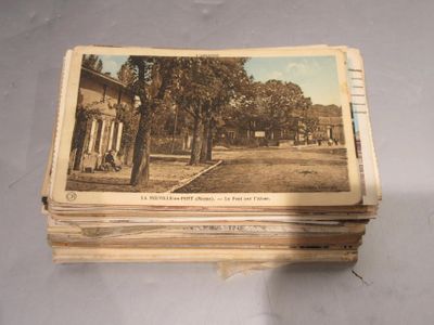 a stack of old postcards sitting on a table