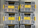 a group of six yellow and black tool boxes sitting on top of a wooden floor