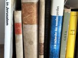 many books that are on a shelf in the room