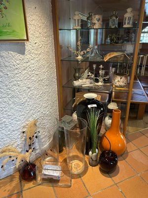many vases and vases on the floor in this room