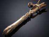 an antique silverware knife with a handle on a black surface