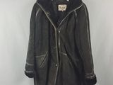 an image of a black leather jacket hanging on a hanger