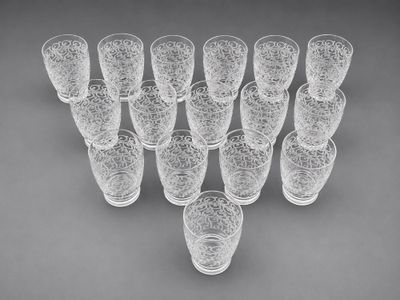 a group of glasses sitting on top of a table next to each other