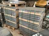 many stacks of boxes stacked on pallets in a warehouse