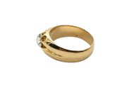 a close up of a gold ring with a diamond in the middle