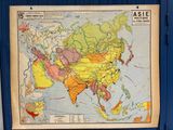 an old map of asia with a blue frame and a map of asia on the wall